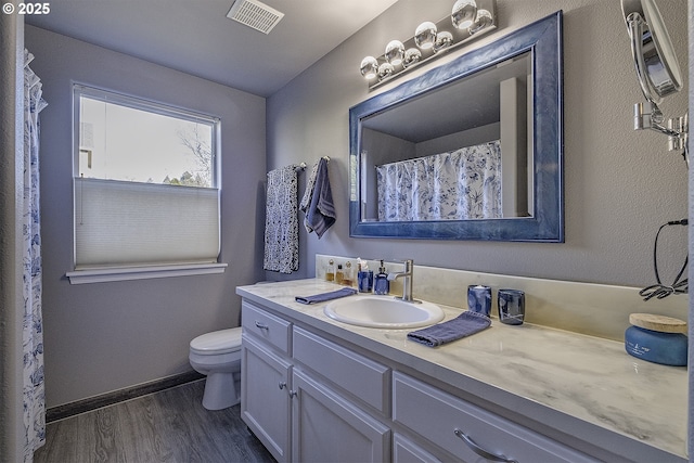 bathroom featuring hardwood / wood-style floors, toilet, and vanity