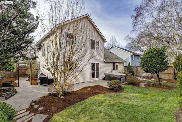 view of property exterior featuring a patio area, a yard, and a hot tub