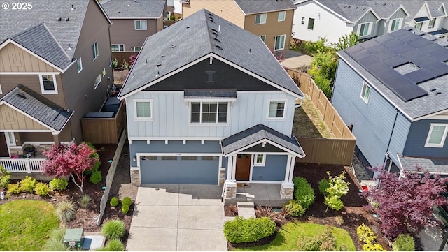 17202 NW Viola St, Portland, OR 97229 - view of front of property with board and batten siding, a residential view, driveway, an attached garage, and stone siding