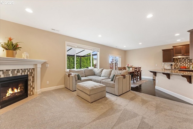17202 NW Viola St, Portland, OR 97229 - living area featuring light carpet, baseboards, a fireplace with flush hearth, and recessed lighting