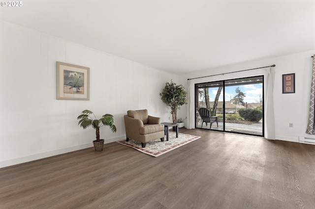 unfurnished room with dark wood-type flooring and a baseboard heating unit