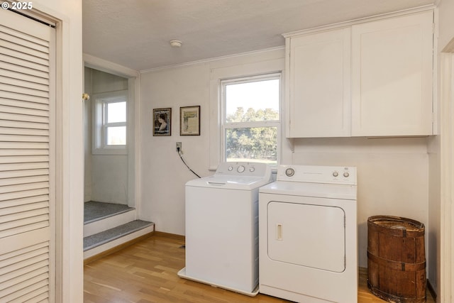 5704 Keene Rd NE, Gervais, OR 97026 - laundry area with independent washer and dryer, cabinet space, light wood finished floors, baseboards, and ornamental molding