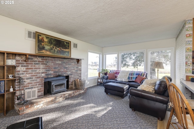 5704 Keene Rd NE, Gervais, OR 97026 - carpeted living room featuring a wood stove and a textured ceiling