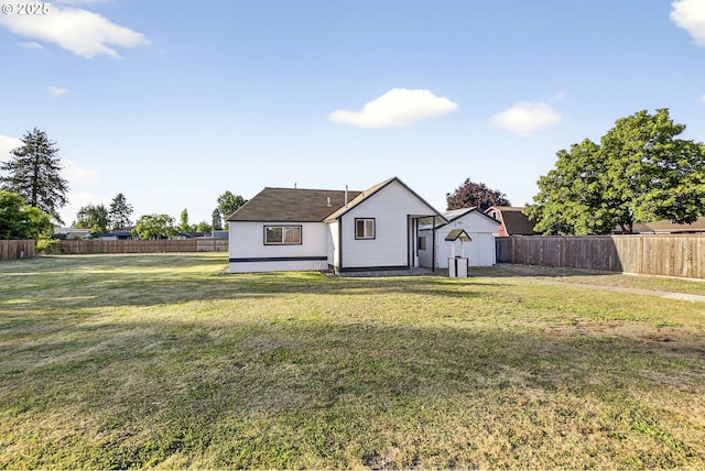 1570 Blaine St, Woodburn, OR 97071 - rear view of property with a fenced backyard and a storage unit
