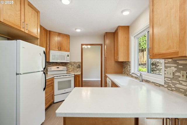 1904 Quinton St, The Dalles, OR 97058 - kitchen with white appliances, a sink, a peninsula, light countertops, and backsplash