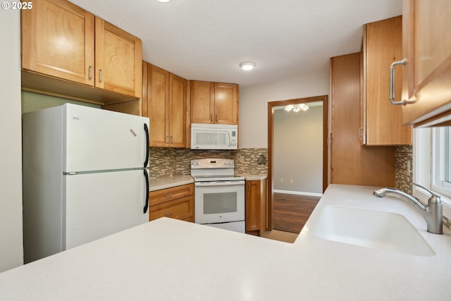 1904 Quinton St, The Dalles, OR 97058 - kitchen featuring white appliances, a sink, backsplash, and light countertops
