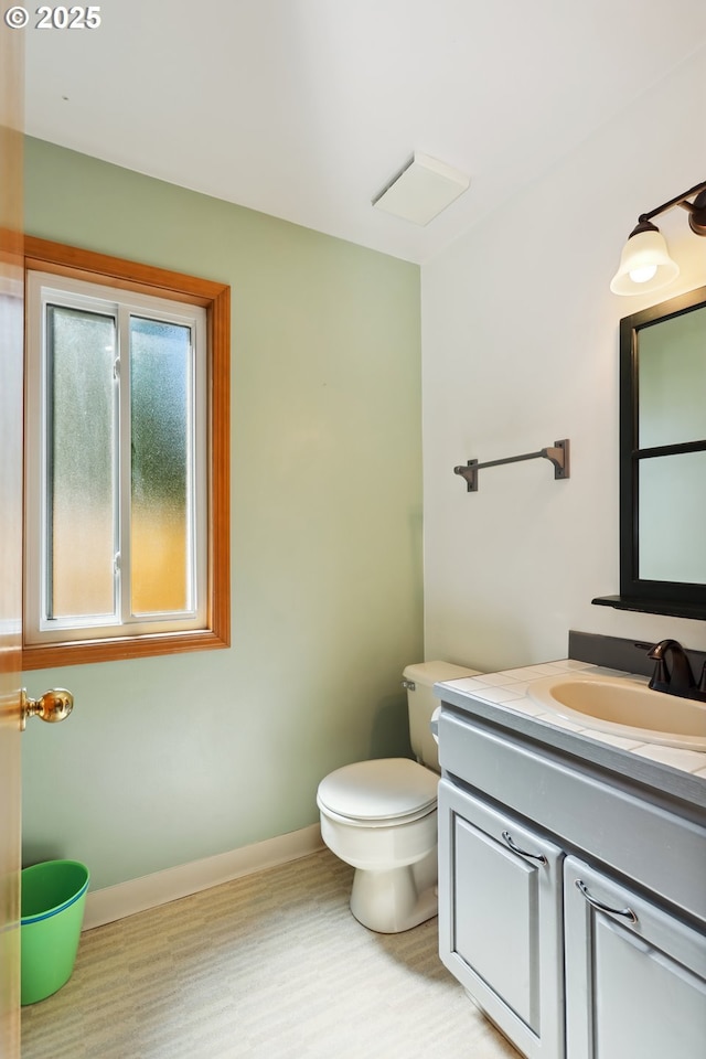 1904 Quinton St, The Dalles, OR 97058 - half bath featuring vanity, toilet, and baseboards