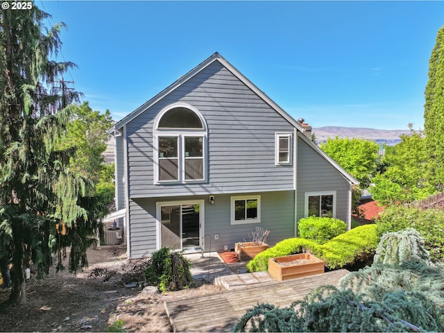 1904 Quinton St, The Dalles, OR 97058 - back of property with central air condition unit, a chimney, a mountain view, and a patio area