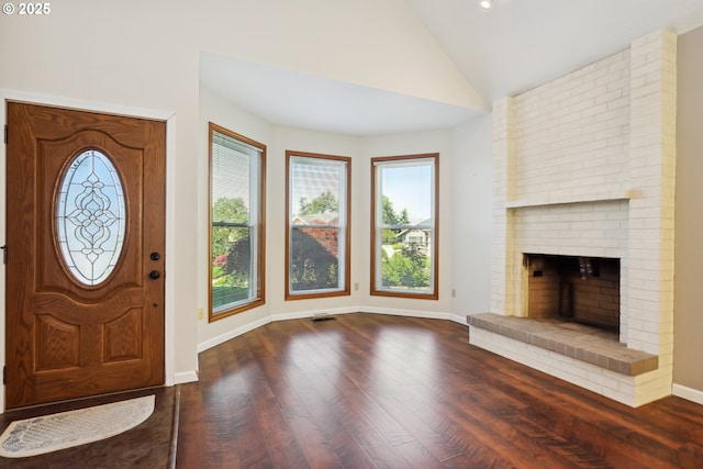 1904 Quinton St, The Dalles, OR 97058 - foyer entrance with lofted ceiling, healthy amount of natural light, wood finished floors, baseboards, and a brick fireplace