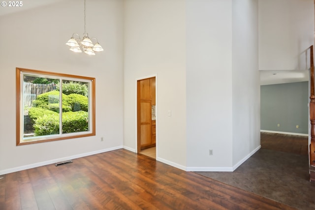 1904 Quinton St, The Dalles, OR 97058 - spare room featuring a high ceiling, a chandelier, wood finished floors, and baseboards