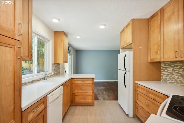 1904 Quinton St, The Dalles, OR 97058 - kitchen featuring white appliances, a sink, tasteful backsplash, a peninsula, and light countertops