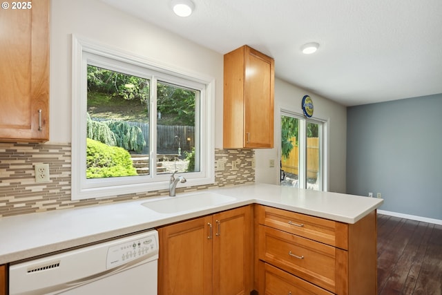 1904 Quinton St, The Dalles, OR 97058 - kitchen with dishwasher, a sink, a peninsula, light countertops, and dark wood-type flooring