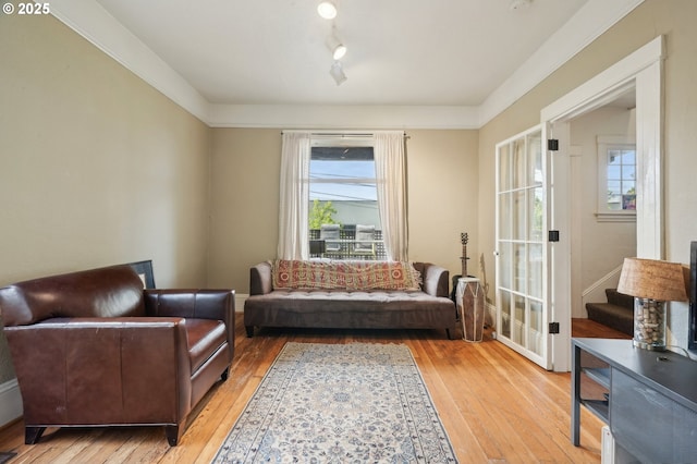 living area featuring hardwood / wood-style floors, healthy amount of natural light, and stairway