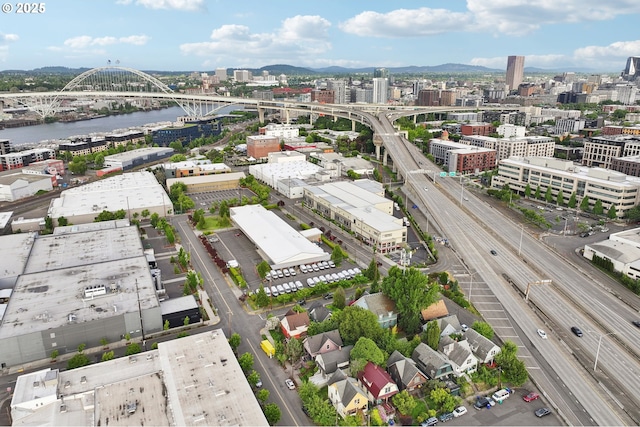 view of urban area featuring a notable bridge, a nearby body of water, and a highway