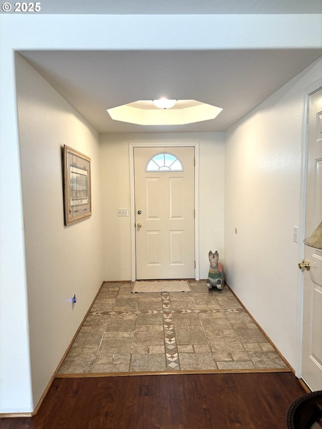 17239 Lumberview Rd, Brookings, OR 97415 - doorway to outside with stone finish floors, baseboards, and a raised ceiling