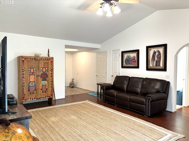 17239 Lumberview Rd, Brookings, OR 97415 - living area with a ceiling fan, arched walkways, lofted ceiling, and dark wood-style flooring