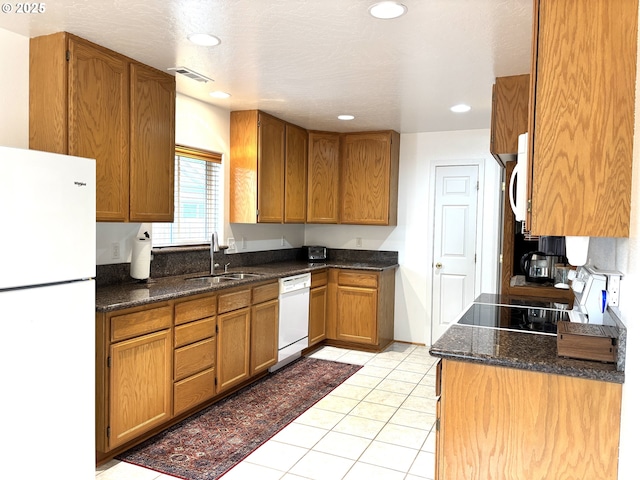 17239 Lumberview Rd, Brookings, OR 97415 - kitchen featuring white appliances, a sink, brown cabinetry, recessed lighting, and light tile patterned floors