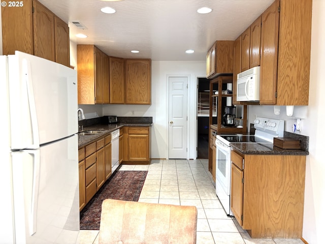 17239 Lumberview Rd, Brookings, OR 97415 - kitchen featuring white appliances, a sink, recessed lighting, brown cabinets, and light tile patterned flooring