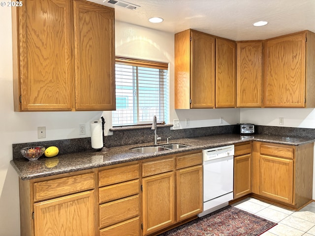 17239 Lumberview Rd, Brookings, OR 97415 - kitchen featuring white dishwasher, a sink, light tile patterned floors, brown cabinets, and recessed lighting