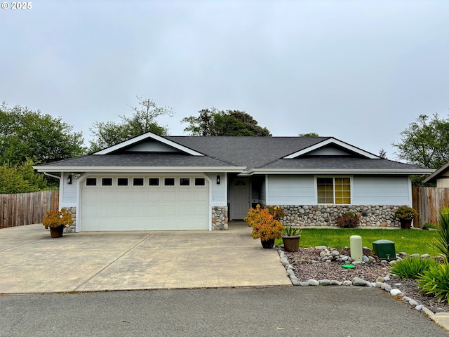 17239 Lumberview Rd, Brookings, OR 97415 - single story home with stone siding, fence, driveway, and a garage
