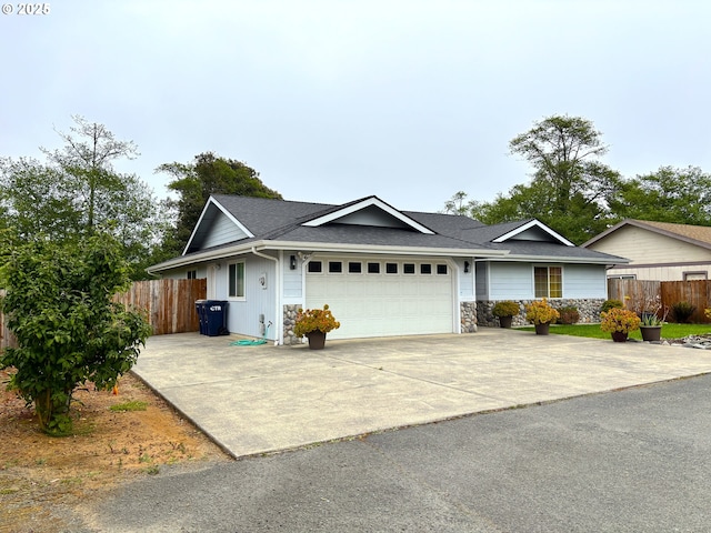 17239 Lumberview Rd, Brookings, OR 97415 - single story home with an attached garage, fence, driveway, and roof with shingles