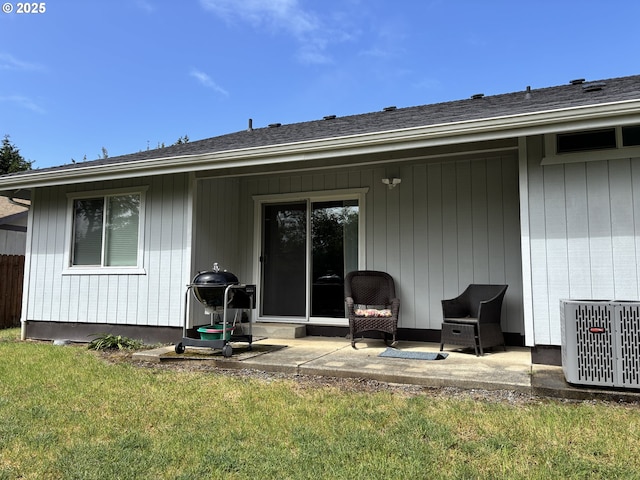 17239 Lumberview Rd, Brookings, OR 97415 - rear view of property featuring a patio, central AC, a lawn, and a shingled roof