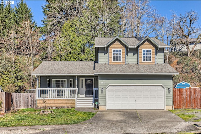 view of front of property with covered porch, driveway, an attached garage, and fence