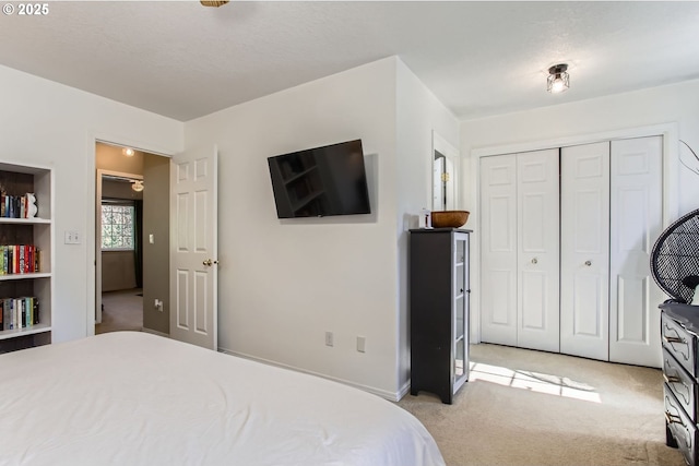 bedroom featuring light carpet and a closet