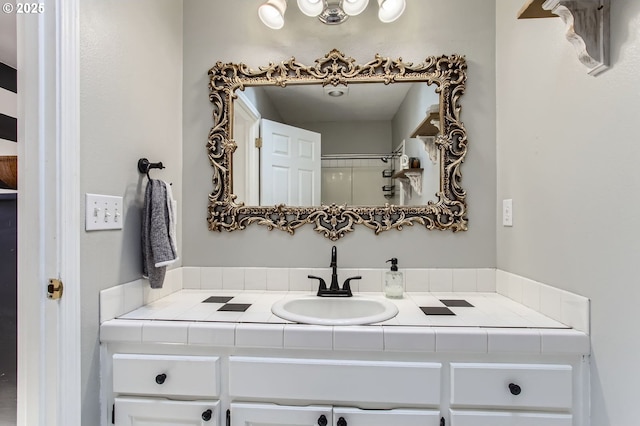 bathroom featuring walk in shower and vanity