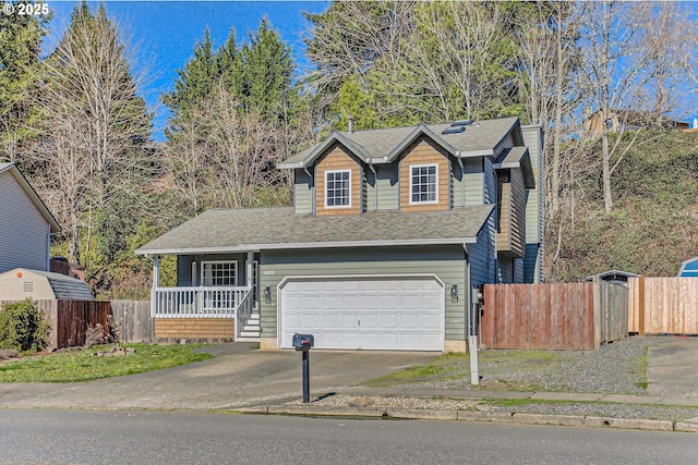 traditional-style home featuring aphalt driveway, roof with shingles, an attached garage, covered porch, and fence