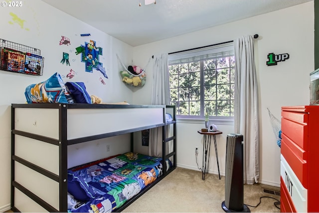 carpeted bedroom featuring visible vents and baseboards