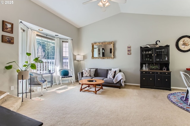 carpeted living area featuring lofted ceiling, ceiling fan, and baseboards