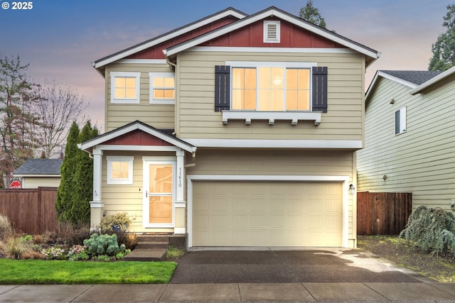 craftsman house featuring concrete driveway, board and batten siding, entry steps, fence, and a garage