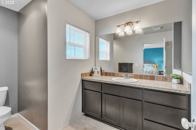 ensuite bathroom with tile patterned flooring, toilet, connected bathroom, vanity, and visible vents