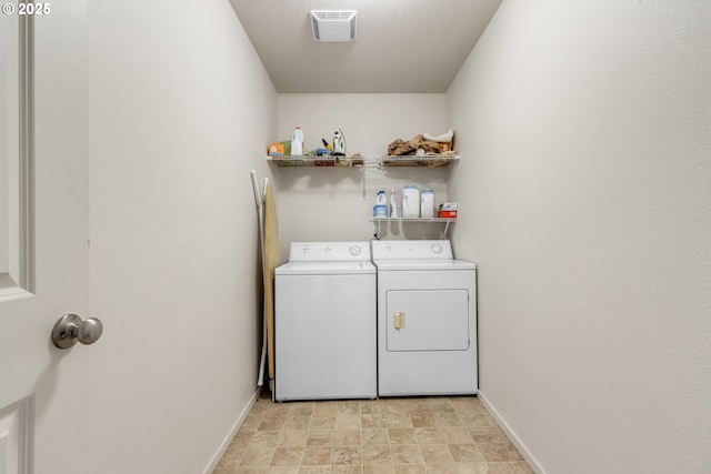 laundry area featuring laundry area, washing machine and dryer, visible vents, and baseboards