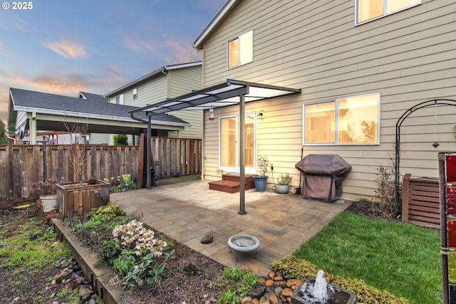 rear view of house with entry steps, a patio area, and fence