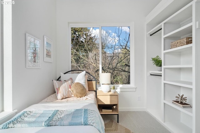 carpeted bedroom with baseboards