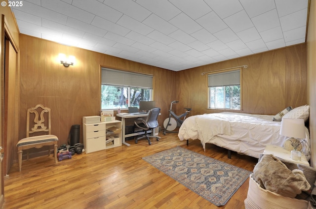 91760 Horse Creek Rd, Mckenzie Bridge, OR 97413 - bedroom featuring multiple windows, wood walls, an office area, and wood finished floors