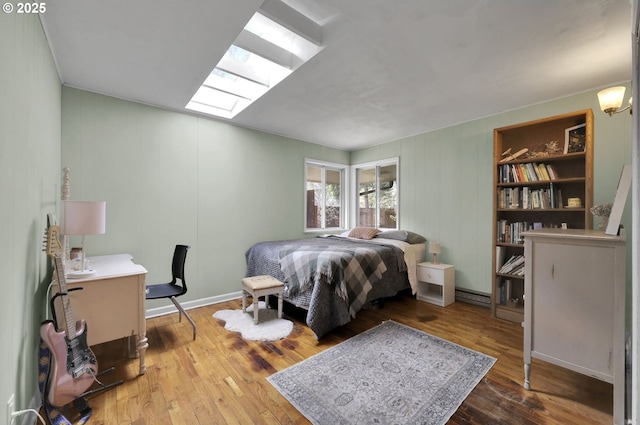 91760 Horse Creek Rd, Mckenzie Bridge, OR 97413 - bedroom with wood-type flooring, a skylight, and a baseboard heating unit