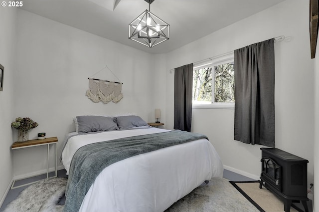 91760 Horse Creek Rd, Mckenzie Bridge, OR 97413 - carpeted bedroom featuring a wood stove, a chandelier, and baseboards