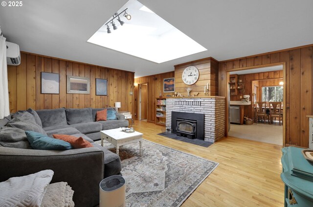 91760 Horse Creek Rd, Mckenzie Bridge, OR 97413 - living room with wood walls, a wall mounted AC, wood finished floors, and a skylight