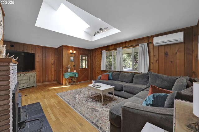 91760 Horse Creek Rd, Mckenzie Bridge, OR 97413 - living area with a wall unit AC, a skylight, wooden walls, light wood finished floors, and a tray ceiling