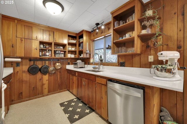 91760 Horse Creek Rd, Mckenzie Bridge, OR 97413 - kitchen with open shelves, stainless steel dishwasher, a sink, brown cabinets, and wooden walls
