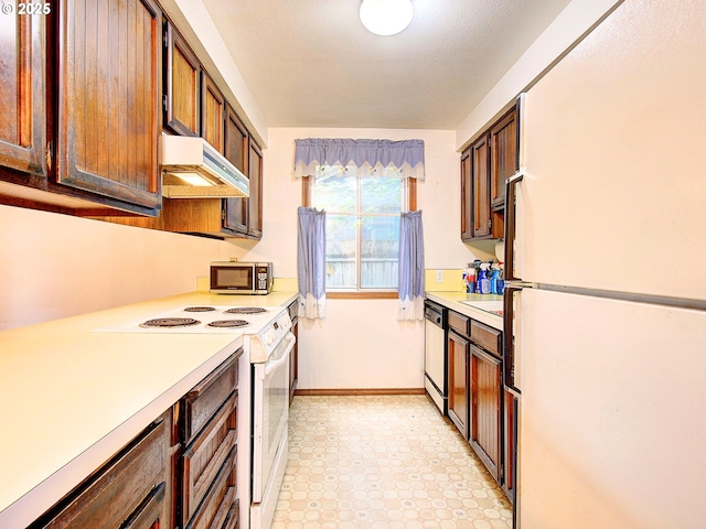 15204 NE 42nd St, Vancouver, WA 98682 - kitchen featuring white appliances, light countertops, under cabinet range hood, baseboards, and light floors