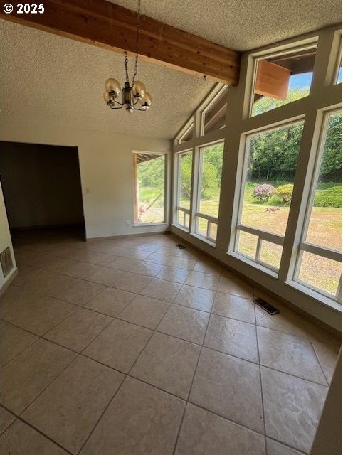73927 Alder Grove Rd, Clatskanie, OR 97016 - unfurnished dining area featuring a textured ceiling, tile patterned floors, beamed ceiling, a chandelier, and high vaulted ceiling