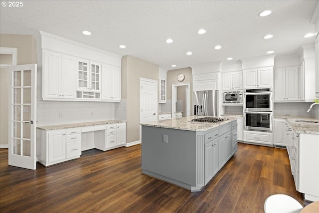 4679 Dogwood Dr, Lake Oswego, OR 97035 - kitchen with a sink, appliances with stainless steel finishes, dark wood-style flooring, white cabinetry, and recessed lighting