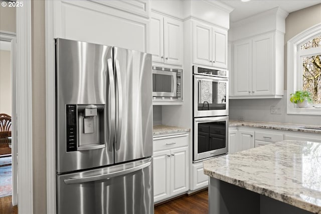 4679 Dogwood Dr, Lake Oswego, OR 97035 - kitchen with appliances with stainless steel finishes, dark wood finished floors, white cabinetry, ornamental molding, and light stone countertops