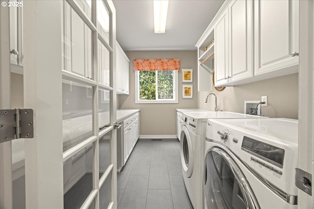 4679 Dogwood Dr, Lake Oswego, OR 97035 - laundry room with cabinet space, washer and clothes dryer, baseboards, and light tile patterned floors