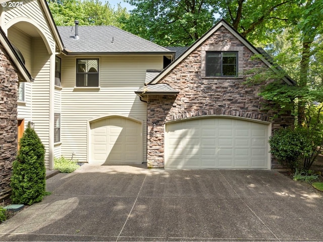 4679 Dogwood Dr, Lake Oswego, OR 97035 - view of front of property featuring stone siding, concrete driveway, and a shingled roof