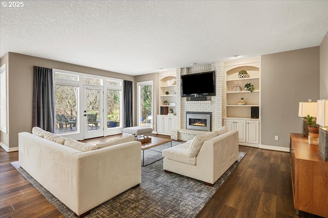 4679 Dogwood Dr, Lake Oswego, OR 97035 - living area featuring a textured ceiling, dark wood-type flooring, baseboards, a brick fireplace, and built in features